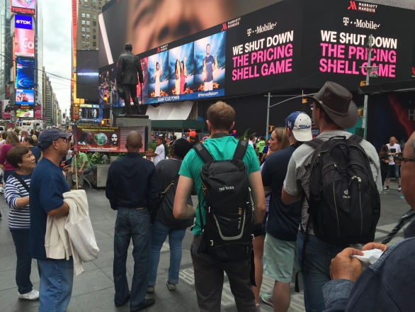 People in Times Square looking at the Divine Signs.