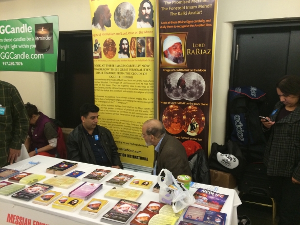 An aspirant discusses the teachings of His Divine Eminence Ra Riaz Gohar Shahi with a member of MFI at the  New Life Expo in New