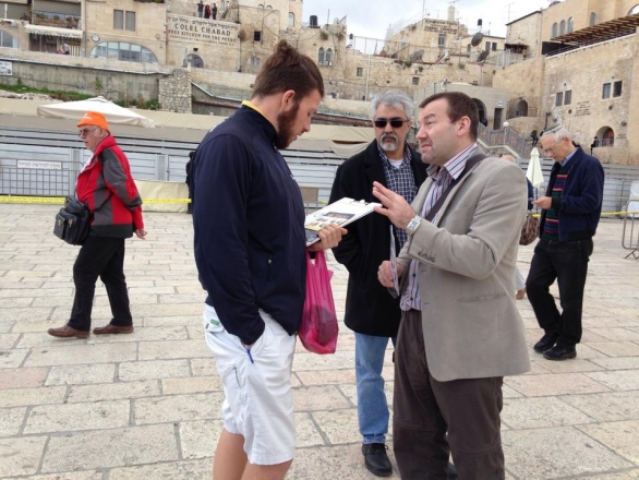 Mr Steve Bell explains the message of divine love to a member of the Christian community in the Old City of Jerusalem, Israel.